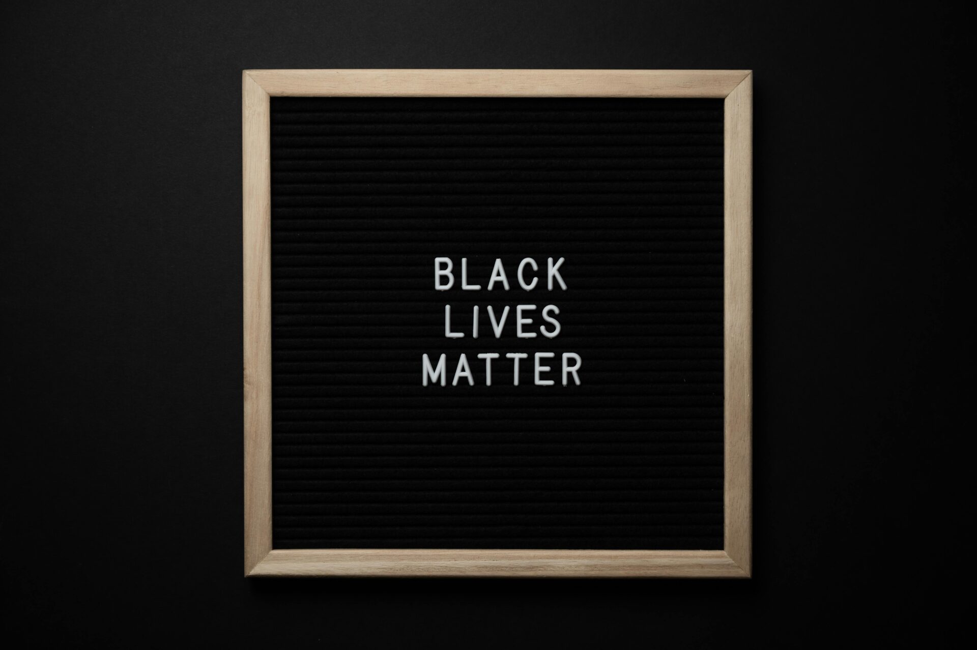 Slogan Black Lives Matter on black board.