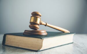 A judge's gavel sitting on top of a book