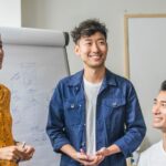 East Asian and South East Asia colleagues standing in a circle having a meeting about their ESEA heritage month plans