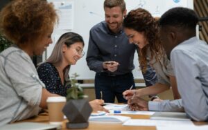 A group of diverse individuals smiling and working together.